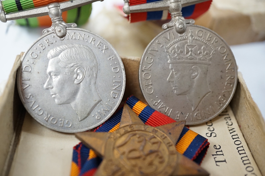 A WWII medal trio comprising a Burma Star, The Defence Medal and the 1939-1945 Medal, contained within their original card issue box, together with a Gurkha cap badge and a few other items. Condition - fair to good.